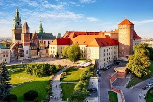 Landscape of oldest city of Poland - Krakow with buildings, grass and roads